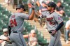 Minnesota Twins' C.J. Cron (24) congratulates Jake Cave (60) on his seventh-inning home run against the Chicago White Sox during a baseball game Thursday, Aug. 29, 2019, in Chicago. (AP Photo/Mark Black)