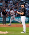 Chicago White Sox starting pitcher Lucas Giolito, right, rubs down a baseball after giving up a two run home run to Minnesota Twins' Nelson Cruz, left, during the third inning of a baseball game Thursday, July 25, 2019, in Chicago. It was the second home run given up by Giolito to Cruz during the game. (AP Photo/Jeff Haynes)