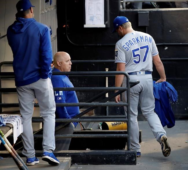 Kansas City Royals starting pitcher Glenn Sparkman, right, walks to the clubhouse after being ejected by home plate umpire Mark Carlson for hitting Chicago White Sox's Tim Anderson with a pitch during the second inning of a baseball game Wednesday, May 29, 2019, in Chicago. (AP Photo/Charles Rex Arbogast)