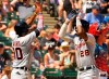 Detroit Tigers Harold Castro (30) and Detroit Tigers Niko Goodrum (28) celebrate Niko's two-run home run against the Chicago White Sox during the sixth inning of a baseball game Thursday, July 4, 2019, in Chicago. (AP Photo/Mark Black)