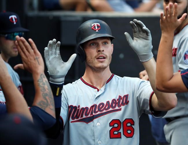 Minnesota Twins' Max Kepler (26) celebrates in the dugout after hitting his second home run of the day against the Chicago White Sox during the seventh inning of a baseball game Saturday, June 29, 2019, in Chicago. (AP Photo/Jeff Haynes)