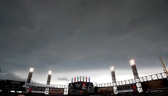 Storm clouds move in over Guaranteed Rate Field during the fourth inning of a baseball game between the Minnesota Twins and the Chicago White Sox, Sunday, June 30, 2019, in Chicago. (AP Photo/Jeff Haynes)
