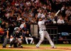 Minnesota Twins' Nelson Cruz watches his two run home run during the fifth inning of a baseball game as Chicago White Sox catcher James McCann (33) and home plate umpire Ed Hickox (15) look on Thursday, July 25, 2019, in Chicago. It was Cruz's third home run of the game. (AP Photo/Jeff Haynes)