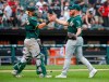 Oakland Athletics' Liam Hendriks, right, celebrates with Chris Herrmann, left, after delivering a final out against the Chicago White Sox in a baseball game, Sunday, Aug. 11, 2019, in Chicago. (AP Photo/Kamil Krzaczynski)