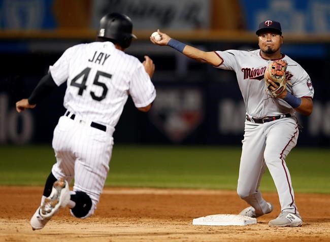 Minnesota Twins second baseman Luis Arraez, right, throws over Chicago White Sox's Jon Jay (45) to complete a double play during third inning of a baseball game Friday, July 26, 2019, in Chicago. (AP Photo/Jeff Haynes)