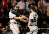 Miami Marlins catcher Jorge Alfaro, left, and relief pitcher Sergio Romo celebrate the team's 2-0 win over the Chicago White Sox after a baseball game Wednesday, July 24, 2019, in Chicago. (AP Photo/Charles Rex Arbogast)