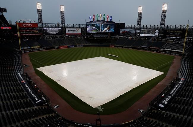 A tarp covers the infield during a rain delay during the fifth inning of a baseball game between the Toronto Blue Jays and the Chicago White Sox, in Chicago, Saturday, May 18, 2019. (AP Photo/Nam Y. Huh)
