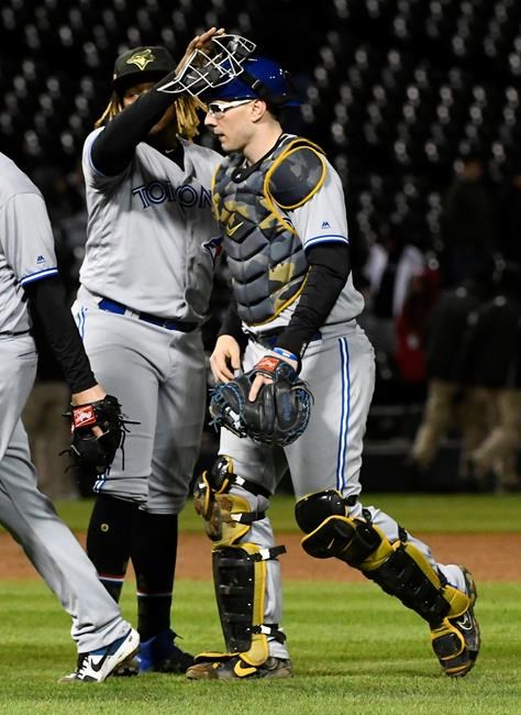 Toronto Blue Jays third baseman Vladimir Guerrero Jr., left, and catcher Danny Jansen celebrate after the team's baseball game against the Chicago White Sox on Friday, May 17, 2019, in Chicago. The Blue Jays won 10-2. (AP Photo/Matt Marton)
