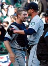 Seattle Mariners catcher Tom Murphy, left,and relief pitcher Connor Sadzeck embrace after a baseball game against the Chicago White Sox in Chicago, Saturday, April 6, 2019. The Mariners won 9-2. (AP Photo/Matt Marton)