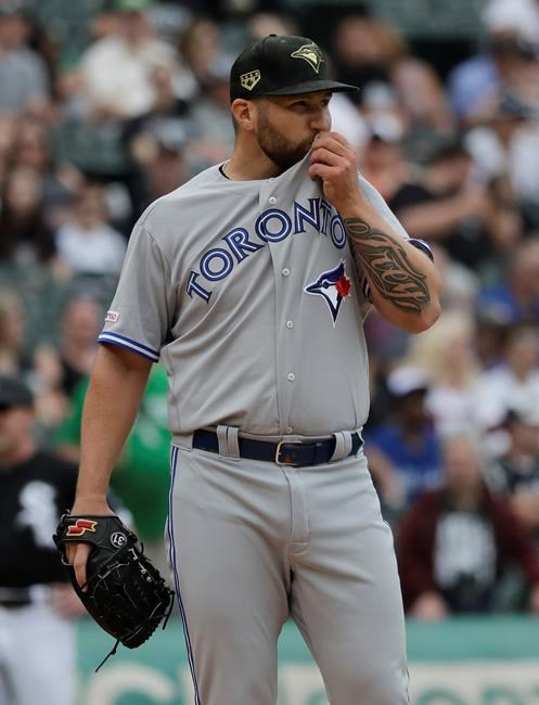 Toronto Blue Jays starting pitcher Ryan Feierabend wipes his face during the first inning of a baseball game against the Chicago White Sox in Chicago, Saturday, May 18, 2019. The White Sox defeated the Blue Jays 4-1 in a rain-shortened game at Guaranteed Rate Field. (AP Photo/Nam Y. Huh)