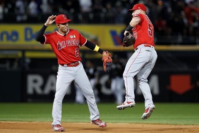 Los Angeles Angels' Andrelton Simmons, left, and Kole Calhoun celebrate their team's win against the Chicago White Sox in a baseball game Saturday, Sept. 7, 2019, in Chicago. (AP Photo/Jim Young)