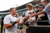 Chicago White Sox catcher James McCann signs autographs after the team's 13-9 win over the Houston Astros after a baseball game Wednesday, Aug. 14, 2019, in Chicago. McCann earlier hit a grand slam in the eighth inning to give the White Sox the win. (AP Photo/Charles Rex Arbogast)
