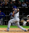 New York Mets' Todd Frazier follows through on an RBI single during the ninth inning of the team's baseball game against the Chicago White Sox on Wednesday, July 31, 2019, in Chicago. (AP Photo/Matt Marton)