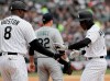 Chicago White Sox's Tim Anderson, right, celebrates with first base coach Daryl Boston, left, after hitting a single during the first inning of a baseball game against the Seattle Mariners, Friday, April 5, 2019, in Chicago. (AP Photo/Nam Y. Huh)