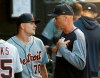 Detroit Tigers bench coach Steve Liddle, right, talks with starting pitcher Tyler Alexander in the dugout, during the fourth inning of a baseball game against the Chicago White Sox Wednesday, July 3, 2019, in Chicago. (AP Photo/Charles Rex Arbogast)