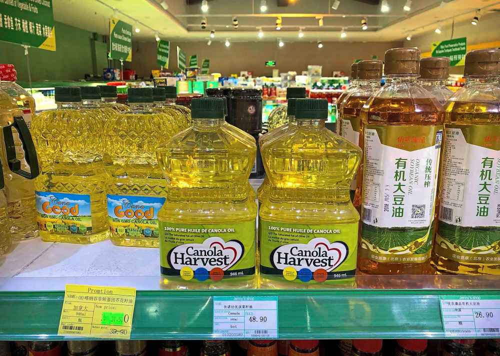 Bottles of Canola Harvest brand canola oil, manufactured by Richardson International, are seen on the shelf of a grocery store in Beijing earlier this month. They could disappear from shelves in China altogether if the trade dispute continues. (Mark Schiefelbein / The Associated Press files)