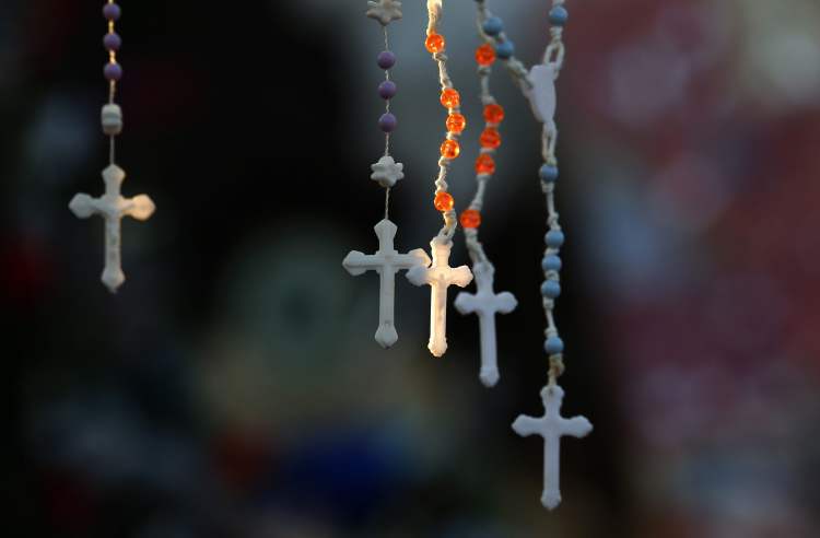 CP
Rosaries are lit by the morning light on a makeshift memorial near the town Christmas tree in the Sandy Hook village of Newtown, Conn.,