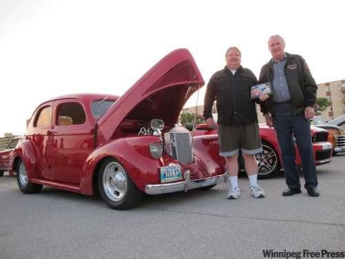 Gary Misko, left, with Fabulous 50’s Ford Club of Manitoba president Albert Lannoo, was presented with the Cruiser of the Week award last Sunday at the Pony Corral cruise night.