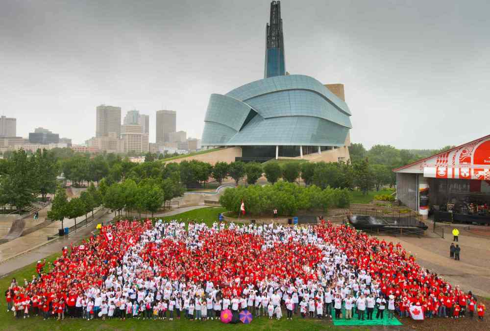 DanHarperPhoto.com / Downtown Winnipeg BIZ
Winnipeggers participate in the 2014 living flag at the Forks.