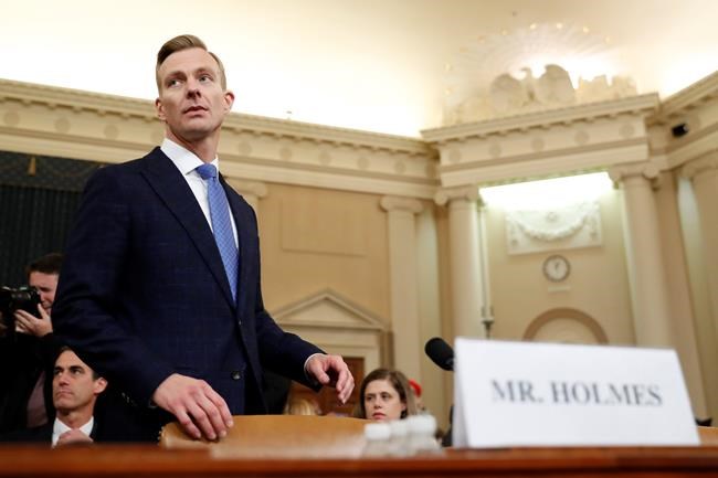 David Holmes, a U.S. diplomat in Ukraine, returns from a break to testify before the House Intelligence Committee on Capitol Hill in Washington, Thursday, Nov. 21, 2019, during a public impeachment hearing of President Donald Trump's efforts to tie U.S. aid for Ukraine to investigations of his political opponents. (AP Photo/Andrew Harnik)