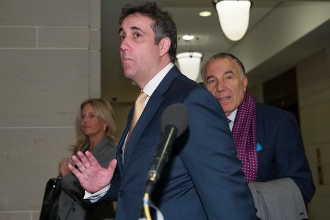 Michael Cohen, center, President Donald Trump's former lawyer, arrives to testify before a closed-door hearing of the House Intelligence Committee accompanied by his lawyer, Michael Monico of Chicago, on Capitol Hill, Thursday, Feb. 28, 2019, in Washington. (AP Photo/Alex Brandon)