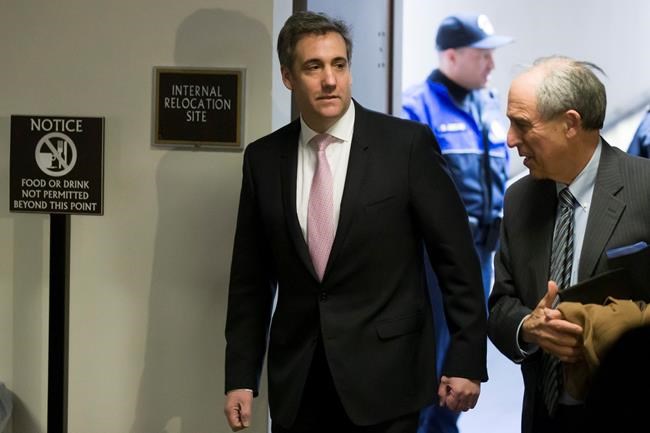 Michael Cohen, left, President Donald Trump's former lawyer, arrives to testify before a closed door hearing of the Senate Intelligence Committee accompanied by his lawyer Lanny Davis of Washington, on Capitol Hill, Tuesday, Feb. 26, 2019, in Washington. (AP Photo/Alex Brandon)