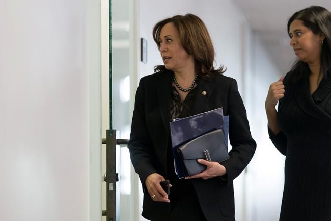 Sen. Kamala Harris, D-Calif., left, arrives to hear testimony from Michael Cohen, President Donald Trump's former lawyer, before a closed door hearing of the Senate Intelligence Committee on Capitol Hill, Tuesday, Feb. 26, 2019, in Washington. (AP Photo/Alex Brandon)