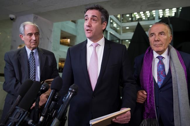 Michael Cohen, center, President Donald Trump's former lawyer, speaks as he departs after testifying before a closed door hearing of the Senate Intelligence Committee accompanied by his lawyers, Lanny Davis, left, of Washington, and Michael Monico of Chicago, on Capitol Hill, Tuesday, Feb. 26, 2019, in Washington. (AP Photo/Alex Brandon)