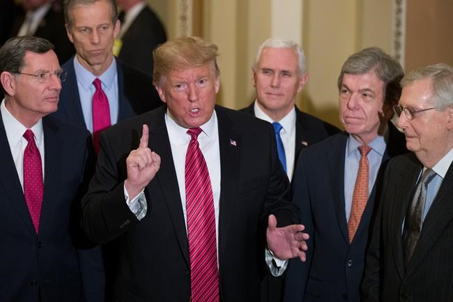 Sen. John Barrasso, R-Wyo., left, and Sen. John Thune, R-S.D., stand with President Donald Trump, Vice President Mike Pence, Sen. Roy Blunt, R-Mo., and Senate Majority Leader Mitch McConnell of Ky., as Trump speaks while departing after a Senate Republican Policy luncheon, on Capitol Hill in Washington, Wednesday, Jan. 9, 2019. (AP Photo/Alex Brandon)