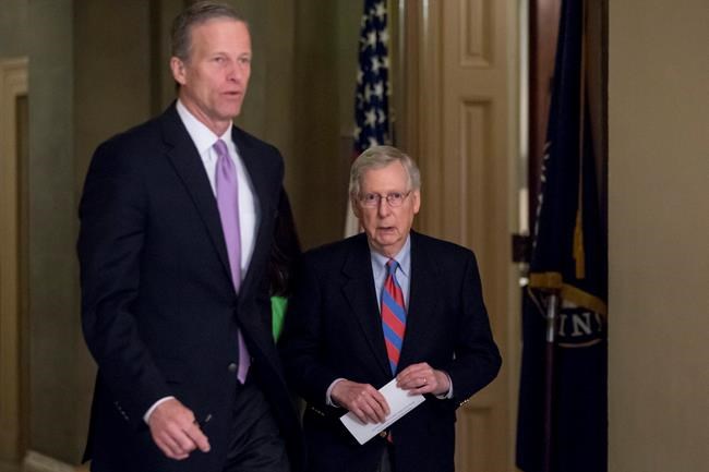 Sen. John Thune, R-S.D., left, and Senate Majority Leader Mitch McConnell of Ky., right, walk into a closed-door meeting with Senate Republicans on Capitol Hill in Washington, Friday, Jan. 25, 2019. (AP Photo/Andrew Harnik)
