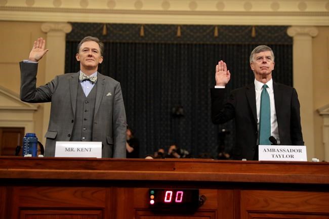 Career Foreign Service officer George Kent and top U.S. diplomat in Ukraine William Taylor, right, are sworn in to testify during the first public impeachment hearing of the House Intelligence Committee on Capitol Hill, Wednesday Nov. 13, 2019 in Washington.(AP Photo/Andrew Harnik)