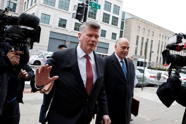 Attorneys Kevin Downing and Thomas Zehnle, right, with the defense team for Paul Manafort, walk from federal court in Washington, Friday, Nov. 30, 2018, after a scheduling conference. (AP Photo/Carolyn Kaster)