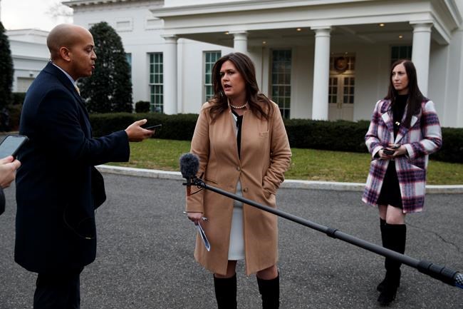 White House press secretary Sarah Huckabee Sanders talks to reporters about the government shutdown outside the White House, Friday, Jan. 4, 2019, in Washington. (AP Photo/Evan Vucci)