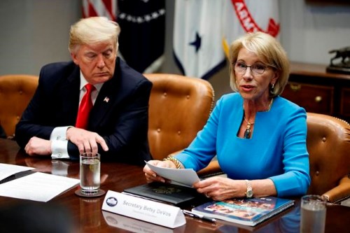 President Donald Trump listens as Secretary of Education Betsy DeVos speaks during a roundtable discussion on the Federal Commission on School Safety report, in the Roosevelt Room of the White House, Tuesday, Dec. 18, 2018, in Washington. (AP Photo/Evan Vucci)