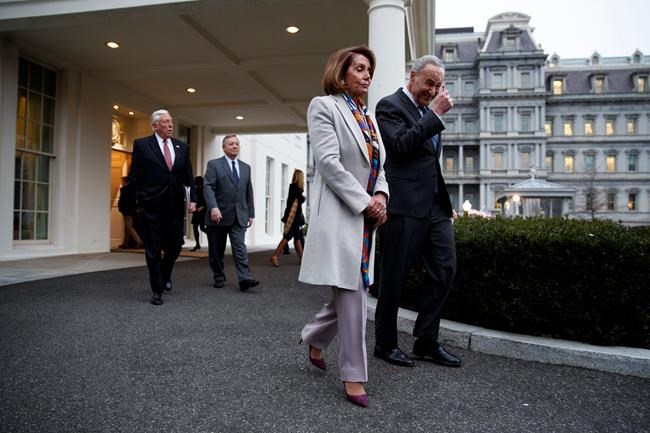 House Democratic leader Rep. Nancy Pelosi of California, and Senate Minority Leader Chuck Schumer, D-N.Y., walk to speak with reporters after a meeting with President Donald Trump on border security at the White House, Wednesday, Jan. 2, 2019, in Washington. (AP Photo/Evan Vucci)