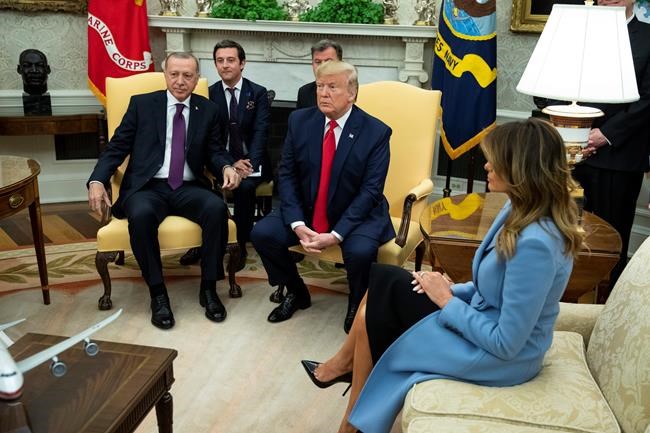 First lady Melania Trump listens as President Donald Trump meets with Turkish President Recep Tayyip Erdogan in the Oval Office of the White House, Wednesday, Nov. 13, 2019, in Washington. (AP Photo/ Evan Vucci)