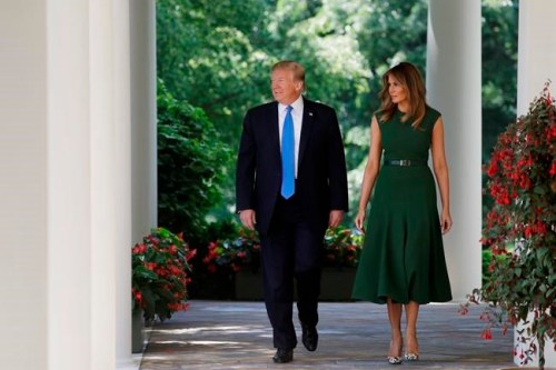 President Donald Trump and first lady Melania Trump walk out to participate in a National Day of Prayer event in the Rose Garden of the White House, Thursday May 2, 2019, in Washington. (AP Photo/Evan Vucci)