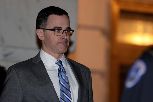 Tim Morrison, a former official at the National Security Council, leaves to testify before the House Intelligence Committee on Capitol Hill in Washington, Tuesday, Nov. 19, 2019, during a public impeachment hearing of President Donald Trump's efforts to tie U.S. aid for Ukraine to investigations of his political opponents. (AP Photo/Julio Cortez)