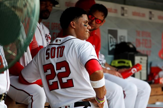 Washington Nationals left fielder Juan Soto (22) talks with teammates in the dugout during their baseball game against the Miami Marlins, Saturday, May 25, 2019, in Washington. (AP Photo/Jacquelyn Martin)