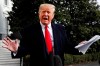 President Donald Trump holds handwritten notes as he speaks to the media about the House Intelligence Committee testimony of U.S. Ambassador to the European Union Gordon Sondland, Wednesday, Nov. 20, 2019, as Trump leaves the White House in Washington, en route to Texas. (AP Photo/Jacquelyn Martin)
