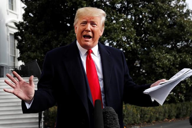 President Donald Trump holds handwritten notes as he speaks to the media about the House Intelligence Committee testimony of U.S. Ambassador to the European Union Gordon Sondland, Wednesday, Nov. 20, 2019, as Trump leaves the White House in Washington, en route to Texas. (AP Photo/Jacquelyn Martin)