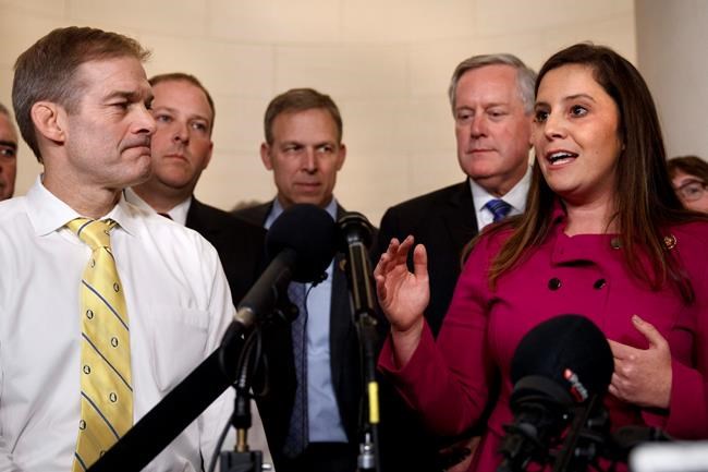Rep. Jim Jordan, R-Ohio, left, listens as Rep. Elise Stefanik, R-N.Y., right, speaks to the media with other Republicans after former U.S. Ambassador to Ukraine Marie Yovanovitch testified to the House Intelligence Committee, Friday, Nov. 15, 2019, on Capitol Hill in Washington, in the second public impeachment hearing on President Donald Trump's efforts to tie U.S. aid for Ukraine to investigations of his political opponents. Left of Stefanik is Rep. Mark Meadows, R-N.C. (AP Photo/Jacquelyn Martin)