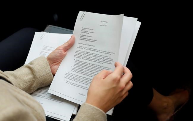 A member of the audience holds a copy of the Whistle-Blower Complaint letter sent to Senate and House Intelligence Committees during testimony by Acting Director of National Intelligence Joseph Maguire before the House Intelligence Committee on Capitol Hill in Washington, Thursday, Sept. 26, 2019. (AP Photo/Pablo Martinez Monsivais)