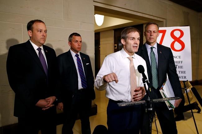 Rep. Jim Jordan, R-Ohio, second from right, speaks to members of the media after National Security Council director for European affairs Alexander Vindman arrived for a closed door meeting to testify as part of the House impeachment inquiry into President Donald Trump, Tuesday, Oct. 29, 2019, on Capitol Hill in Washington. (AP Photo/Patrick Semansky)