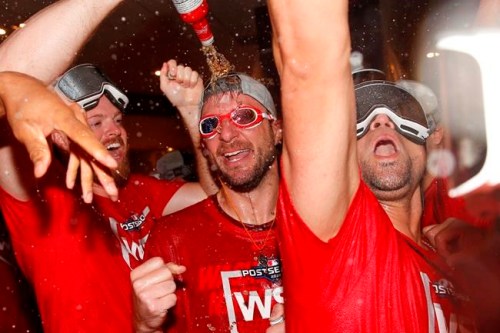 In this photo taken Oct. 1, 2019, Washington Nationals pitcher Max Scherzer, center, celebrates with teammates after winning a National League wild-card baseball game against the Milwaukee Brewers in Washington. All eyes will be on Scherzer at the World Series. And that is fitting in many ways. The Nationals star has an unusual optical condition: one eye blue, one brown. The Houston Astros, however, need only concern themselves about his arm. (AP Photo/Patrick Semansky)