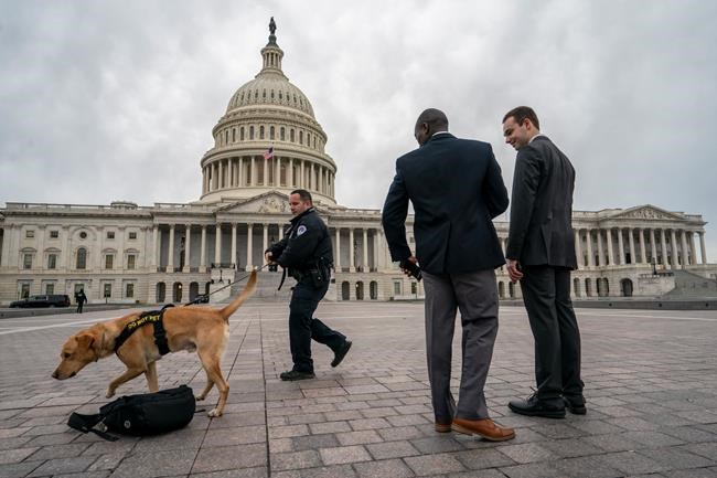 A police officer and K-9 do a routine security check at the Capitol as the partial government shutdown lurches into a third week with President Donald Trump standing firm in his border wall funding demands, in Washington, Monday, Jan. 7, 2019. After no weekend breakthrough to end a prolonged shutdown, newly empowered House Democrats are planning to step up pressure on Trump and Republican lawmakers to reopen the government. (AP Photo/J. Scott Applewhite)