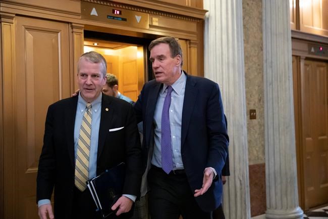 Sen. Dan Sullivan, R-Alaska, left, and Sen. Mark Warner, D-Va., the vice-chair of the Senate Intelligence Committee, arrive at the Senate prior to a vote on ending the partial government shutdown, at the Capitol in Washington, Thursday, Jan. 24, 2019. (AP Photo/J. Scott Applewhite)