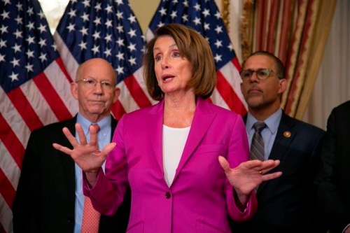Speaker of the House Nancy Pelosi, D-Calif., flanked by Rep. Peter DeFazio, D-Ore., left, and Rep. Anthony Brown, D-Md., talks to reporters after signing a House-passed a bill requiring that all government workers receive retroactive pay after the partial shutdown ends, at the Capitol in Washington, Friday, Jan. 11, 2019. (AP Photo/J. Scott Applewhite)