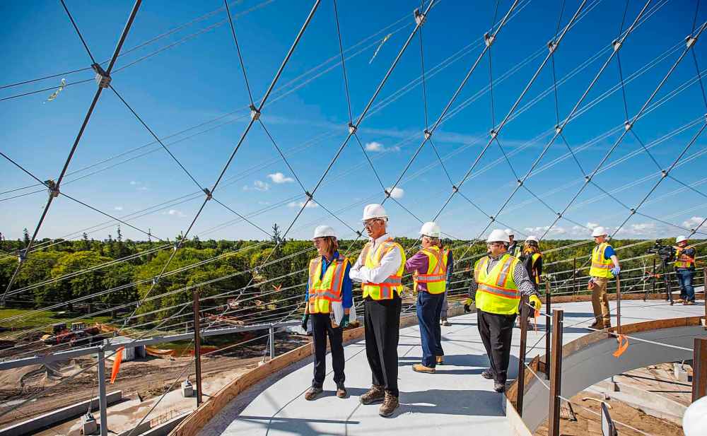 MIKE DEAL / WINNIPEG FREE PRESS
Margaret Redmond (left), President and CEO of Assiniboine Park Conservancy and Hartley Richardson (second left), President and CEO James Richardson & Sons Limited takes in the view from the canopy walkway during construction of Canada's Diversity Gardens at Assiniboine Park Tuesday morning.
