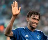 FILE - In this Aug. 11, 2019 file photo Hamurg's Bakery Jatta waves to fans after a match of Chemnitz against Hamburg in Chemnitz, Germany. Hamburger SV has reinforced its support for midfielder Bakéry Jatta as the dispute over his identity continues to inflame tempers in Germany’s second division. The affair began with a report by Sport Bild magazine suggesting that Jatta – who became the first refugee to play in the Bundesliga when he made his debut for Hamburg in April 2017 – has been playing under a false name and is in fact two years older than he claims to be. (Robert Michael/dpa via AP)